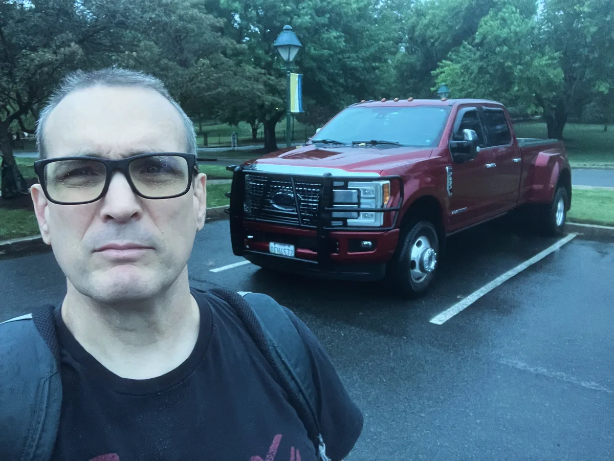 Thad standing in front of Big Red, his brother's truck