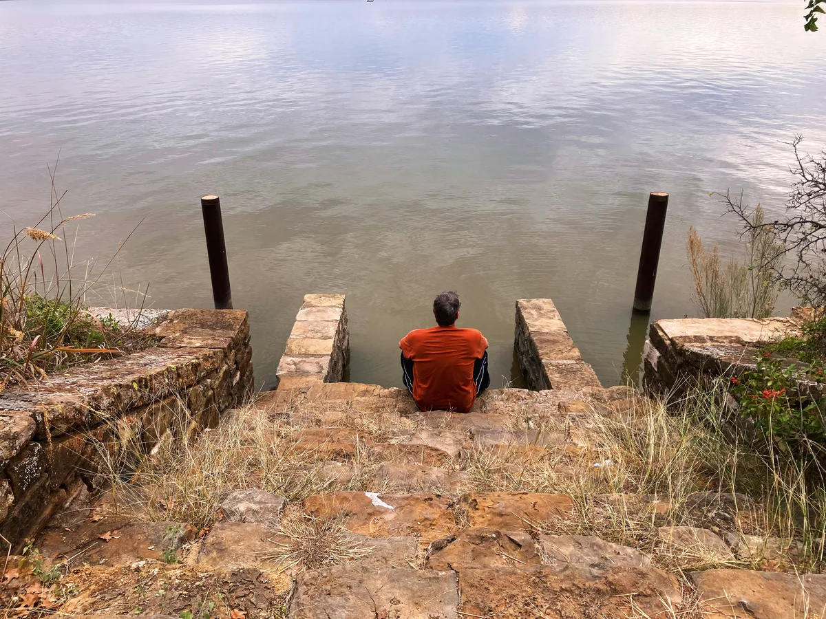 Thad sitting at the bottom of the stone staircase at Lake Brownwood