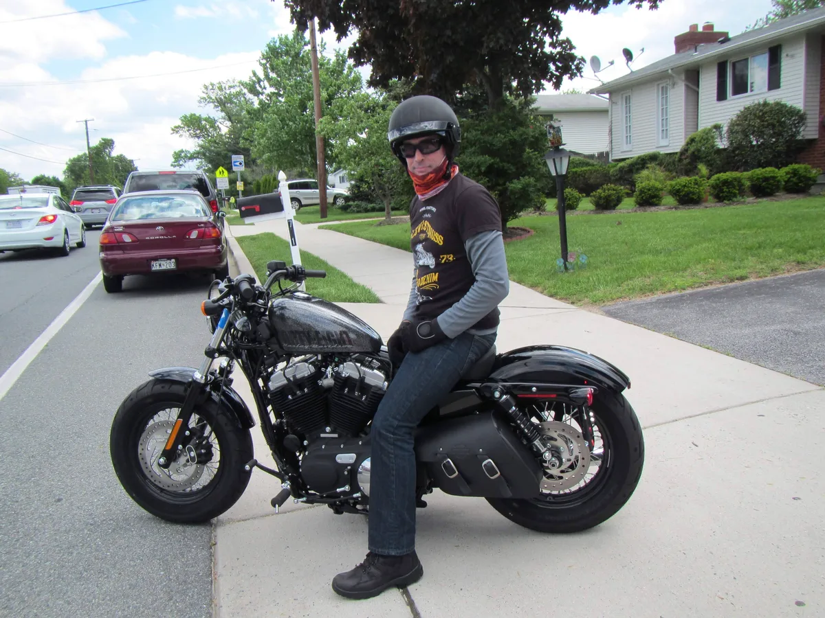 Thad sitting on his black Harley Davidson Forty-Eight motorcycle