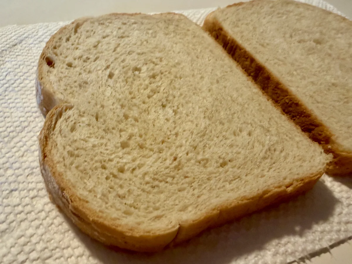 Close-up of two plain sourdough bread slices before spreading.