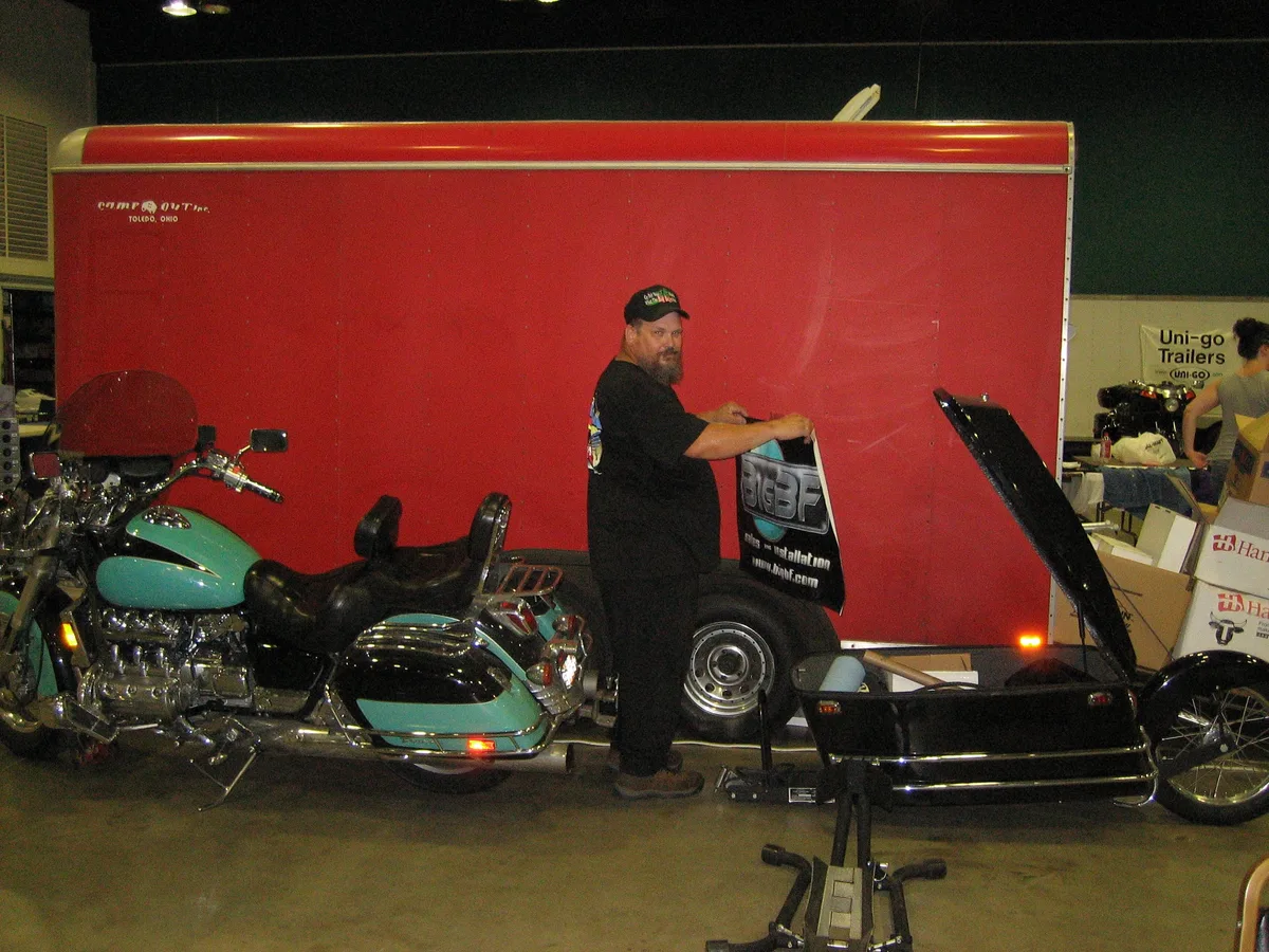 Bill standing by his Honda Valkyrie motorcycle holding the finished BigBF sign