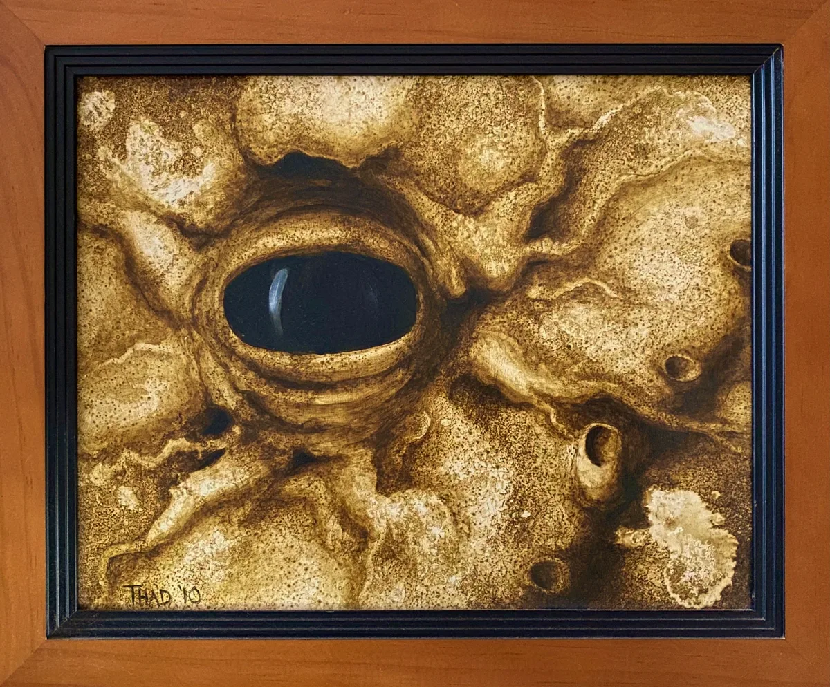 Painting titled Elder's Eye, showing an octopus-like eye surrounded by rock-like textured skin.