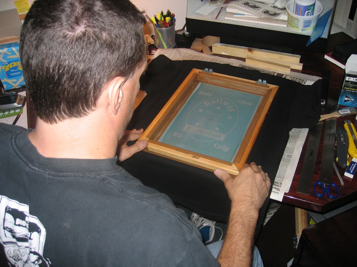 Screen positioned over a black shirt, ready to print