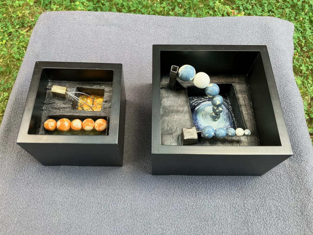 Both pieces displayed outside, rotated to show a different view of the beads and panels.