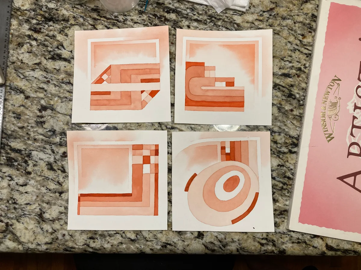 Four finished vermilion watercolor paintings arranged on a countertop